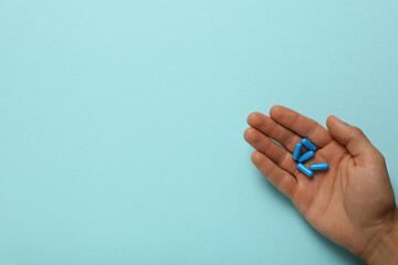 Blue viagra pills in a man's hand