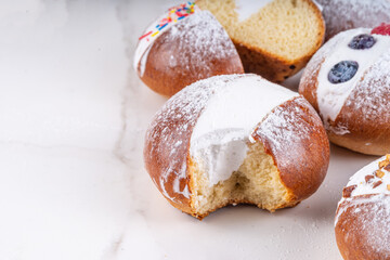 Homemade italian sweet Maritozzi buns, breakfast dessert brioche stuffed with whipped cream, with various topping, nuts, fruit 