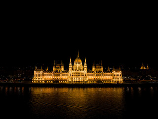 Fototapeta premium Landscape of the Hungarian Parliement Building at night in Budapest Hungary on the side of the Danube