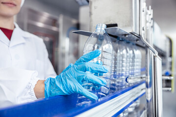 women worker working in hygiene factory in clean line drinking water Pet plastic bottle production