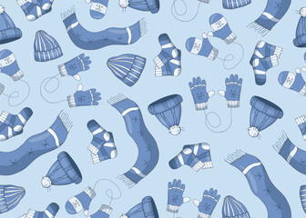 Seamless pattern with winter clothes, scarfs, hats, gloves and mittens and socks wirt snowflakes on a blue background.