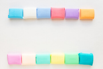Colorful molded plasticine clay isolated on white background with copy space for text. Back to school 