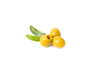 Delicious green olives isolated on white background. Olive and olive tree branches on a white table. Delicacy.