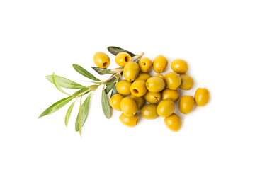 Delicious green olives isolated on white background. Olive and olive tree branches on a white table. Delicacy.