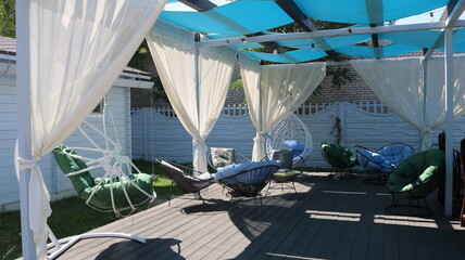 a private relaxation area on the sun terrace with comfortable chairs and wicker swings, the use of...