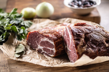 Smoked pork neck cut into two parts ready for heat treatment