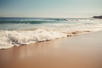 A soothing background image of a sandy beach the ocean breaking in