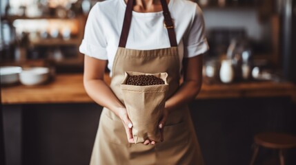 Small cafe owner or barista woman holding coffee beans in jute bag - obrazy, fototapety, plakaty