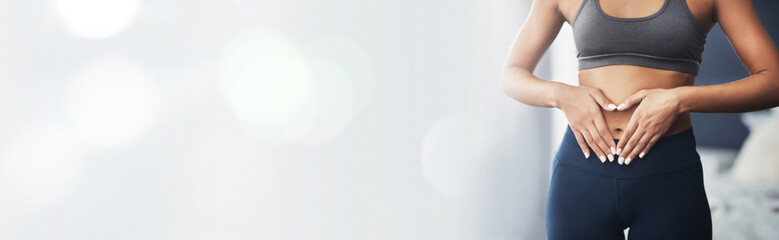 Heart hands, bokeh and stomach of woman with gut health, diet or detox results at gym for wellness...