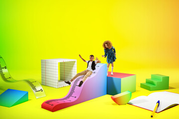 Playful little boy and girl, children playing on 3D items, school supplies, riding on ruler....
