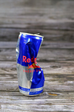 Cairo, Egypt, October 1 2023: Crushed dented Red Bull energy drink, a brand of energy drinks created and owned by the Austrian company Red Bull GmbH, Its slogan, (Red Bull Gives You Wings), isolated