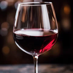 Fotobehang Close-up of a glass of red wine - classy and indulgent © olegganko