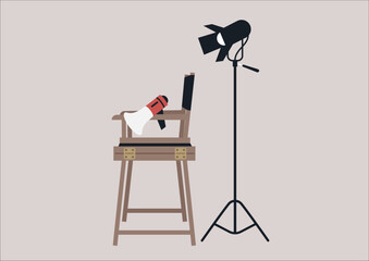 A behind-the-scenes scenario featuring movie equipment: a softbox lighting, a megaphone, and a director's chair