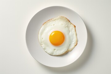 One fried egg on white plate isolated on white background, top view - 658224254