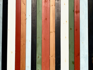 Colorful texture of painted in different bright colors wooden boards close up. Colorful surface of...