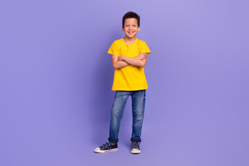 Full body photo of charming young boy crossed hands confident wear yellow outfit isolated on purple color background © deagreez