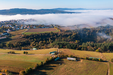 Bird's-eye view of fields and forests near Presberg/Germany with morning fog over the Wisper Valley