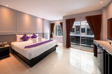 Hotel Room Decorated single double bedroom with nice white bed sheets purple decorative colours. the colour scheme is designed for thailand and interior is m modern classical