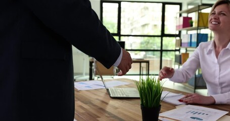Male and female handshakes and effective negotiations and demonstrating mutual respect and intent to establish a working relationship. Man in suit greeting partner and business