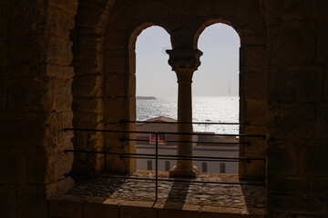 View of Cefalù, the city, the cathedral and its castle. Panorama seen from above of the whole landscape. Rough sea during sunset. The most beautiful places in Sicily. Excellent tourist destination.