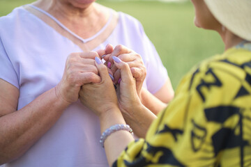 Love Beyond Time: This poignant image of two elderly women sharing a heartfelt moment hand-in-hand speaks volumes about the enduring nature of love and companionship.