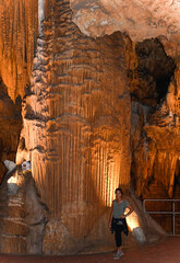 Woman with backdrop of Stalactites and Stalagmites, Luray Caverns, Virginia