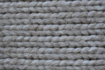 Symmetrical plain beige hand knitted woollen fabric with textured patterns, Hand knitted beige wool fabric with a pattern texture