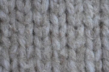 Symmetrical plain beige hand knitted woollen fabric with textured patterns, Hand knitted beige wool fabric with a pattern texture