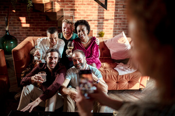 Diverse group of friends getting their picture taken together at home