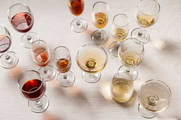 Glasses with different wine types on the table, wine tasting, party and celebration concept.
