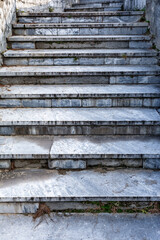 Old abandoned marble staircase in the city park close-up