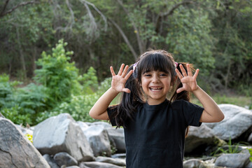 Sweet little girl super happy to be on vacation in a natural environment.