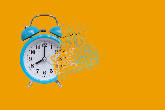 The time is running out. Dissolving alarm clock disappears on orange background.