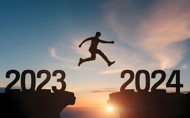 Happy new year 2024, Silhouette Man jumping from 2023 cliff to 2024 cliff on sky background. ...