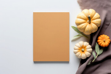 autumn still life with empty blank for copy space with background of pumpkins and textile