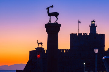 Statues of deer at Mandraki harbor entrance at sunrise, Rhodes Greece