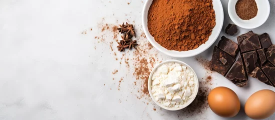 Foto op Plexiglas Arrangement of chocolate cake ingredients top view of sugar eggs cocoa powder flour on marble table cake making process © AkuAku