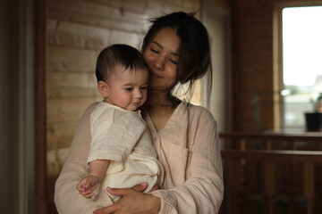 Unbreakable Bonds: A young mom and her baby girl share an intimate embrace, accented by the soft...