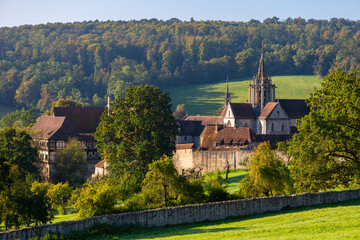 Fototapeta na wymiar “Kloster Bebenhausen“ monastery and castle near Tübingen in southern Germany on a sunny late summer morning. Medieval landmark monument and tourist attraction with church tower and truss houses.