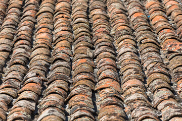 Architecture textures, detailed view of a old and damage italian orange roof tile texture, typical and traditional shale stone material, used on traditional on construction