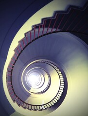 almost hypnotic effect of a spiral staircase that rises upwards  with an antique effect