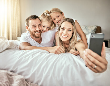 Selfie, happy and portrait of family on the bed for bonding and relaxing together at modern home. Smile, love and girl children laying and taking a picture with parents from Australia in bedroom.