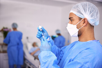 Man, doctor and syringe for vaccine, injection or cure in healthcare with face mask at hospital....
