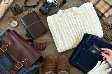 Travel flat lay - Laying out clothes and accessories for packing for cold weather travel trip