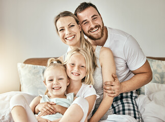 Fototapeta na wymiar Happy, love and portrait of family on the bed for bonding and relaxing together at modern home. Happiness, smile and girl children sitting with mother and father from Australia in bedroom at house.