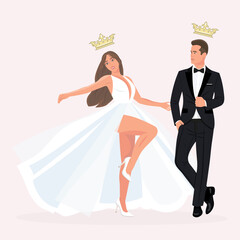 The bride in white dress and groom in black tuxedo dance at the wedding.