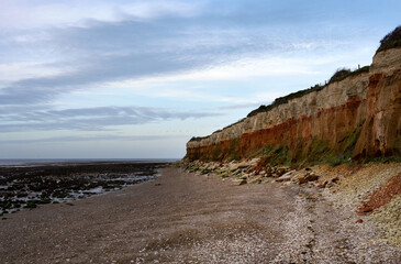Fototapeta na wymiar The colourful Hunstanton cliffs of white chalk, red chalk and orange sandstone, Norfolk, England