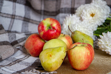 Naklejka na ściany i meble bright fresh apples and flowers on the table