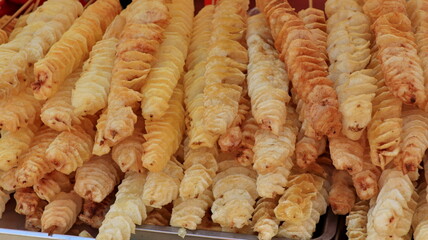 Potato chips on a stick. Natural chips are fried and sold at the fair