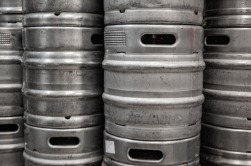 Range of stacked beer casks of kegs in brewery.
